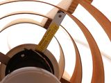 a close up view of a ceiling fan with a measuring tape on it
