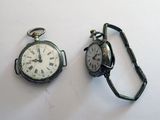 deux types différents de montres de poche posées sur une surface blanche
