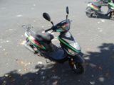 two mopeds that are parked in the parking lot