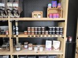 a wooden shelf filled with jars and containers of food