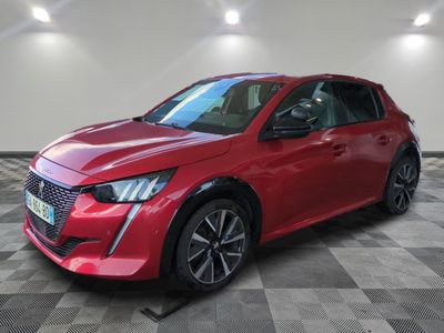 a red car parked in a garage with a checkered floor