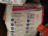 a bag of flour sitting on the floor next to a bag of flour