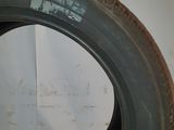 a close up of a tire on a counter with a wall in the background