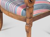 pair of early 20th century walnut armchairs with striped upholstered cushions