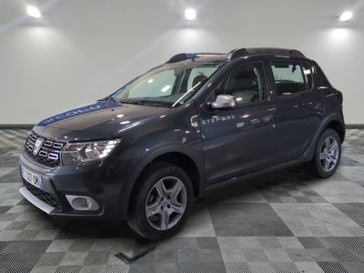 a picture of a grey dacia parked in a garage
