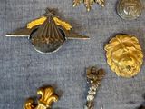 a lot of gold and silver items on a blue cloth