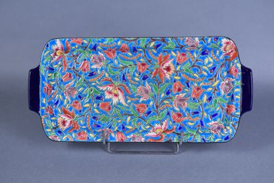 blue and red serving tray with flowers and leaves on it