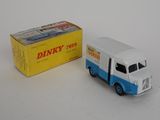 a blue and white toy truck next to a box of dinky toys