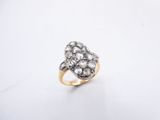 a close up of a gold and diamond ring on a white surface
