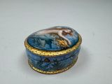 a blue and gold box with a mermaid on it