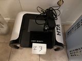 a black and white microwave sitting on a tiled floor