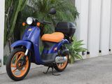 a blue and orange motorcycle parked on the side of the road