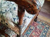 a wooden chair with a floral upholstered seat