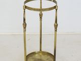 an image of a brass table with a glass top on a white floor