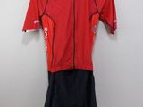 a close up of a red shirt and shorts on a hanger