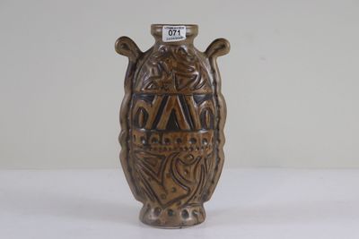 un vase marron posé sur une table, sur laquelle figure un numéro