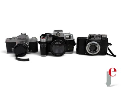 three cameras sitting next to each other on a white surface