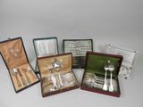 four silverware items in a case on a table