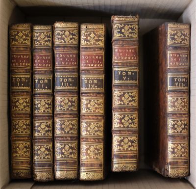 a box full of old books sitting on top of a table