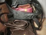 a black bag with a laptop in it sitting on top of a suitcase