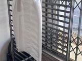 a towel rack with a towel hanging on it in front of a window