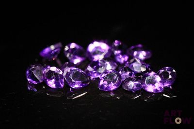 purple amethorate faceted gems on a black background