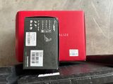 a red box sitting on top of a pile of luggage