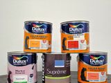 four cans of duluxx paint sitting on a table