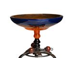 a blue and orange bowl on a stand on a white background