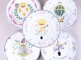quatre assiettes à motifs différents sur une surface blanche