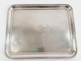 an old silver tray on a white table with a white background