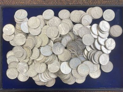 a lot of silver coins in a blue tray