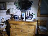 a dresser with a mirror on top of it in a room