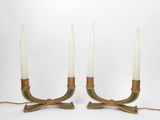a pair of brass candles with green and white candlesticks