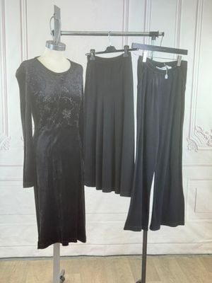 two dresses on a mannequin stand in front of a white wall