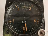 a close up of a clock on a white surface