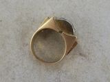 an image of a gold ring with a stone in the middle