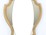 an image of a gold oval shaped mirror on a white wall