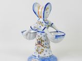 an image of a figurine of a woman holding a basket