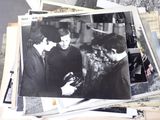 a lot of old photos of the beatles on the table