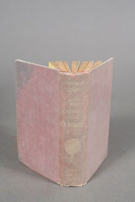 a pink book that is open on a table