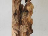 a wooden sculpture of a man and a woman