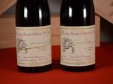 two bottles of wine sitting next to each other on a table