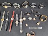 a lot of watches that are sitting on a table
