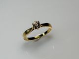 a close up of a gold ring with a flower on it