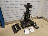 a camera that is sitting on a tripod in front of a wall