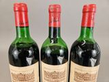 three bottles of wine sitting on top of a table next to each other