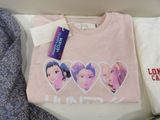 a pink shirt with a picture of four girls on it