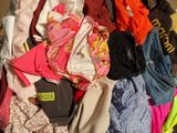 a pile of clothes that is sitting on the floor