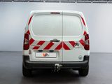 a white van with red and white stripes parked in a garage